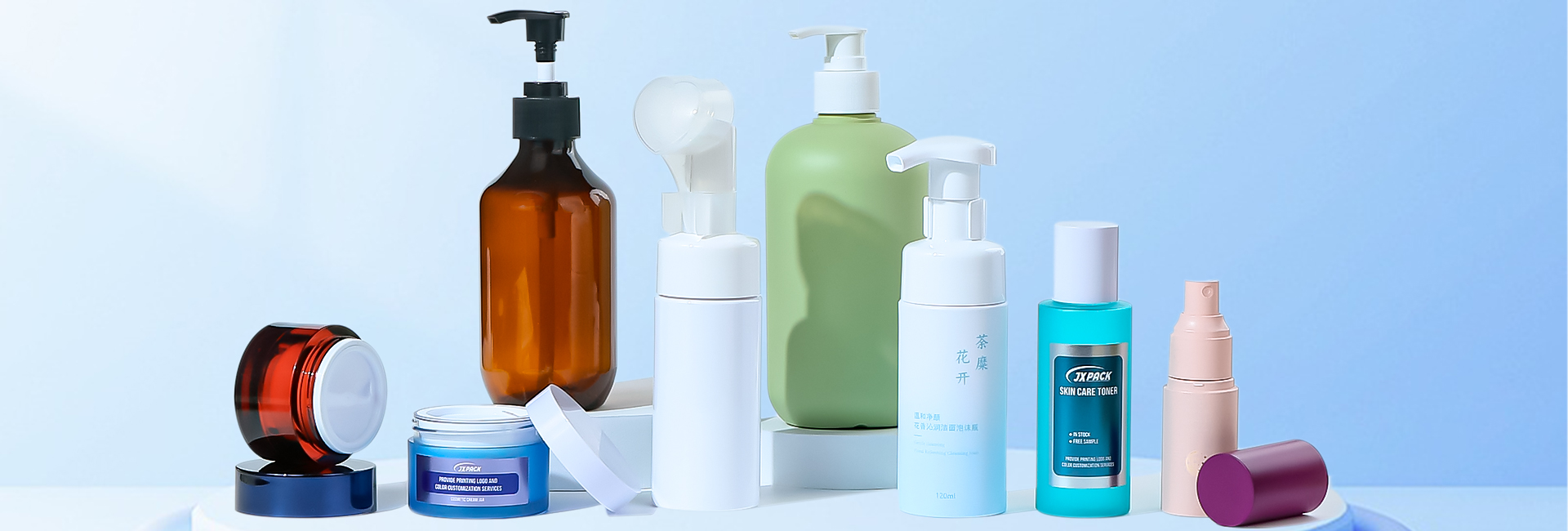 Luxury cosmetic products displayed on a marble counter with soft lighting and glass bottles in the background